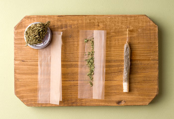 cooking cigarettes with marijuana on a wooden board