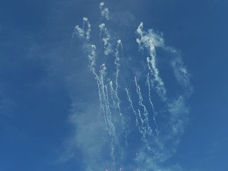 Naklejka na ściany i meble Fireworks shooting up into the blue skies