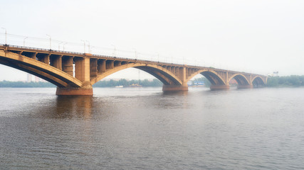 Communal bridge over the Yenisei river in Krasnoyarsk during the foggy weather
