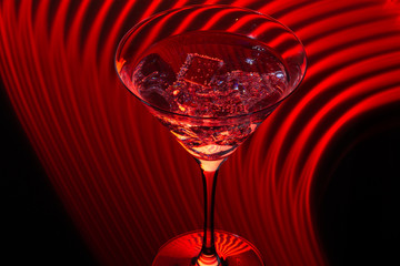 Long exposure martini glass with ice and olives