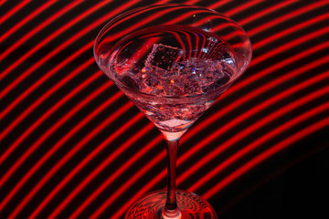 Long exposure martini glass with ice and olives