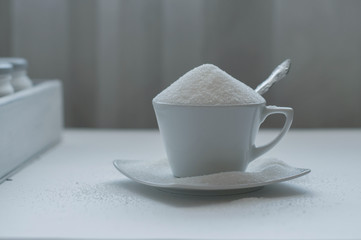 Tea cup full of white sugar