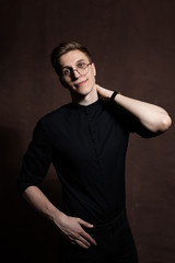 Man in round glasses and a black shirt.