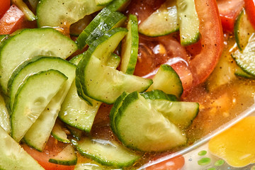 Fresh tomato and cucumber salad close up photo