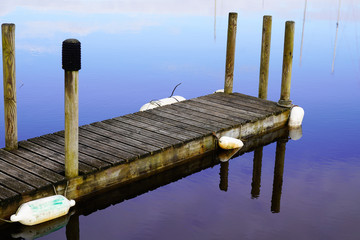 blue hour water reflection sky sunrise fishing boat wooden pontoon in sunset Lake Hourtin in...