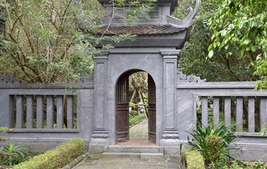 Fototapeta na wymiar Grey Gate and Fence, Suoi Tien Temple, Trang An, Vietnam