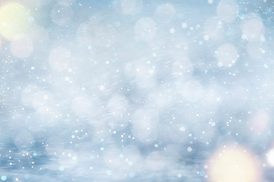 Christmas and New Year background with snow and light bokeh