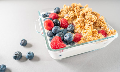 Breakfast of granola and wild berries. Delivered in a glass plate