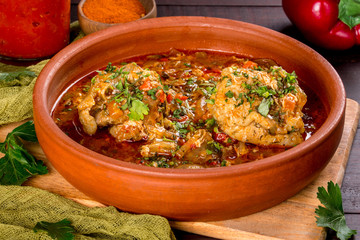 Georgian dish chakhokhbili in a clay plate. Shot in the decor