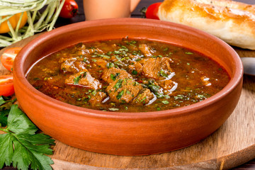 Georgian dish chakhokhbili in a clay plate. Shot in the decor