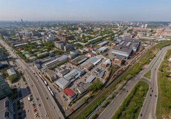 Fototapeta na wymiar Industrial area and Malysheva street in Yekaterinburg city, Russia. Aerial, summer, sunny