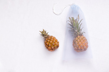 grocery eco bag of blue color with tropical fruit pineapple on a white background. copy space