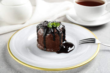 Delicious warm chocolate lava cake on grey table