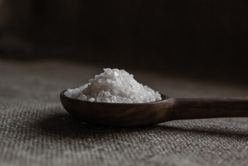 Natural rock salt crystals in a spoon.