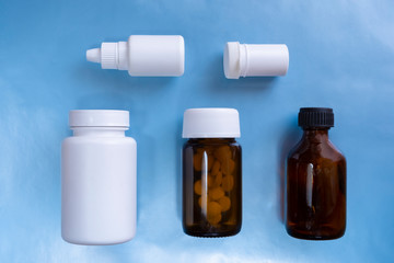 Packaging design concept. Set with various medical bottles on blue background. Pharmacy concept. Health cure collection.