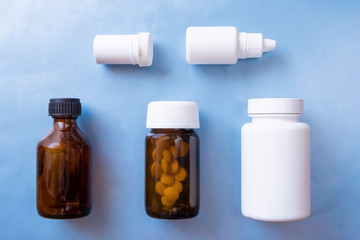 Packaging design concept. Set with various medical bottles on blue background. Pharmacy concept. Health cure collection.