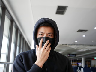 asian men ware mask to protect pm 2.5 and coronavirus at Thailand airport.