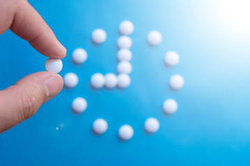 9 o clock made of pills. Abstract medical background. Medication time concept. Medicine drug icon. Time to take medicine.