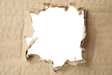 Hole in brown cardboard on white background