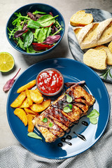 Delicious grilled ribs served on light grey table, above view