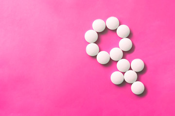 Obraz na płótnie Canvas Female gender sighn made of pills. Woman's health care concept. Medical design. Pharmacy concept.