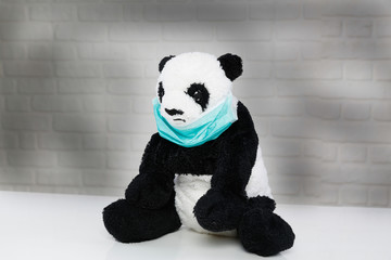 Conceptual disease face mask on panda. Coronavirus and panda concept. © bulentcamci