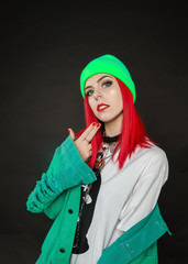 Teenager girl with red hair posing in studio.