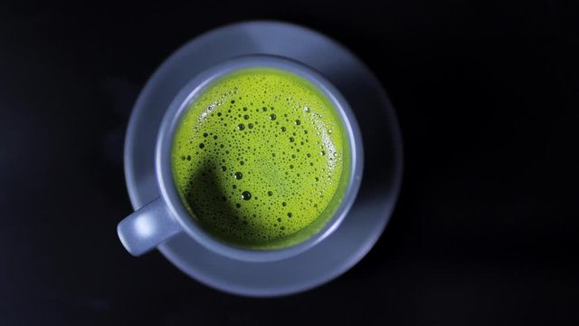 Close-up view of matcha tea on black background