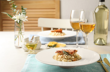 Delicious chicken risotto with rosemary served on table