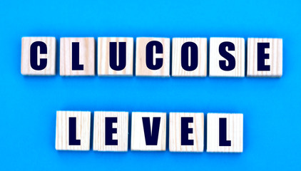 concept words glucose level on cubes on a blue background
