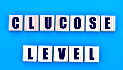 concept words glucose level on cubes on a blue background