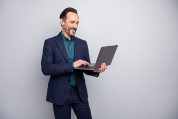 Photo of attractive business man holding notebook reading colleagues report email friendly good mood formalwear blazer shirt pants blue suit isolated grey color background