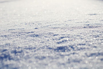 Obraz premium Abstract background. Shining snow. Snow covered field. Close-up of a snowdrift.
