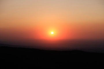 Beautiful sunset in foothils. Orange sun.