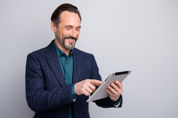 Photo of positive mood business man guy holding hands digital e-book tablet browsing read corporate...