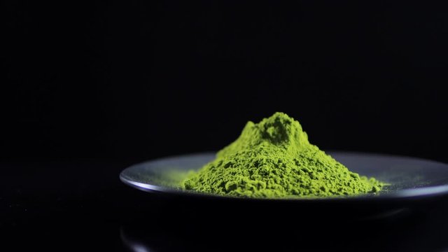 Close-up view powdered matcha tea on black