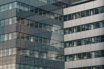 Geometric background with many window rows. Modern building structure. Many glasses on a huge wall. European classic skyscraper with copy space.