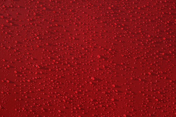 Droplets pattern on red backdrop. Juice splash. Red juicy surface drops, great design for any purposes. Texture background, pattern. Summer bright background. Bright sweet color.