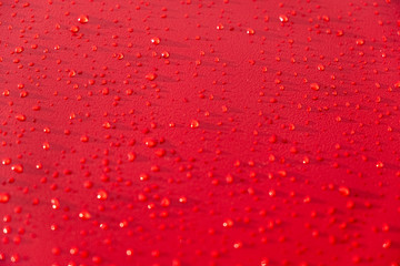 Droplets pattern on red backdrop. Juice splash. Red juicy surface drops, great design for any purposes. Texture background, pattern. Summer bright background. Bright sweet color.