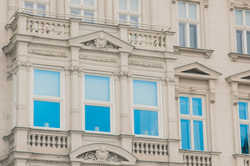 Geometric background with many window rows. Modern building structure. Many glasses on a huge wall. European classic skyscraper with copy space.