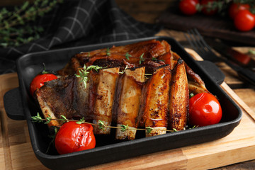 Delicious roasted ribs served on table, closeup
