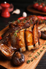 Delicious roasted ribs served on table, closeup