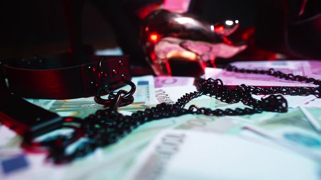 Composition dominatrix concept. A golden piggy bank stands among the money. 