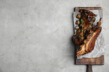 Delicious roasted ribs served on grey table, top view. Space for text