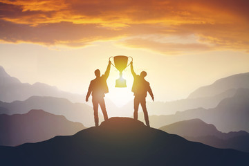 Silhouette of Business people team with trophy cup with clipping path at sunset evening sky...