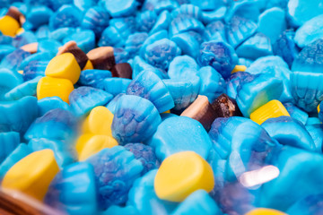Blue, yellow and brown slices of marmalade chewing sweets. Sweet beautiful treat. Bright colorful...