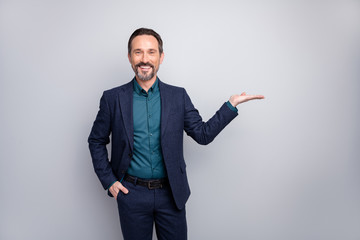 Photo of attractive sales manager worker man advising novelty holding innovation product on open arm formalwear shirt trousers blazer plaid blue suit isolated grey color background