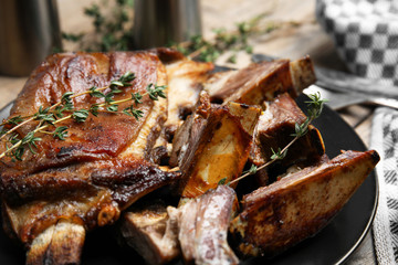 Delicious roasted ribs served on plate, closeup