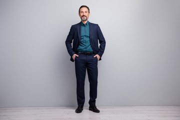 Full length photo of handsome business mature man hands in pockets well-dressed good-looking...