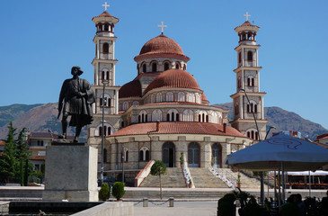 Statue of an Albanian warrior, Orthodox Cathedral in background. Korca (Korce), Albania